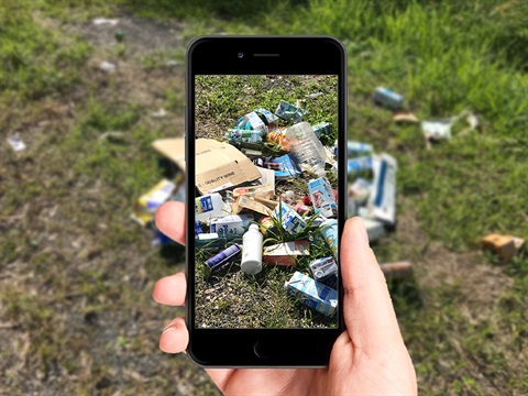 Snapping a photo of illegal dumping